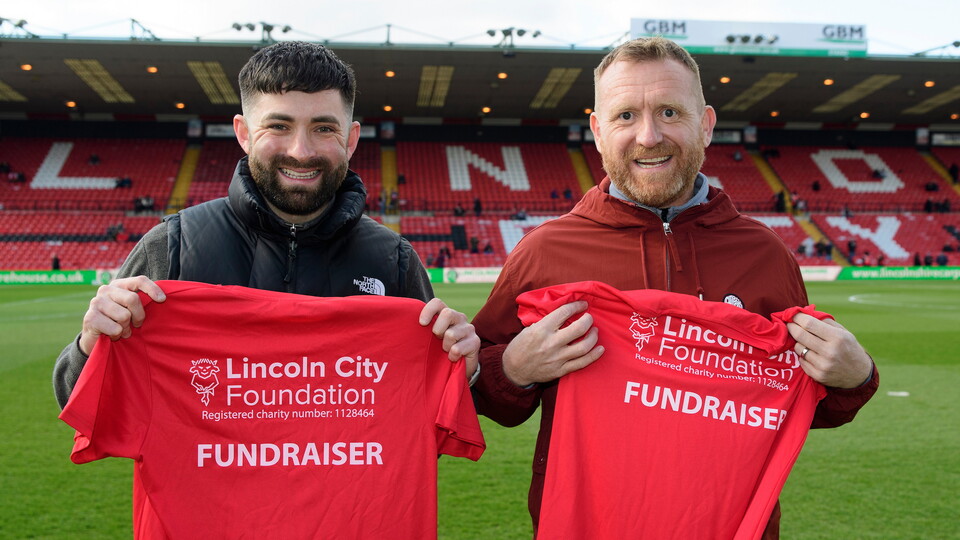 Jasper Caudwell, left, and Garey Hutchinson, right, with their London Marathon running shirts. They will be running in aid of Lincoln City Foundation prior to the EFL Sky Bet League One match between Lincoln City and Bristol Rovers at LNER Stadium, Lincoln.