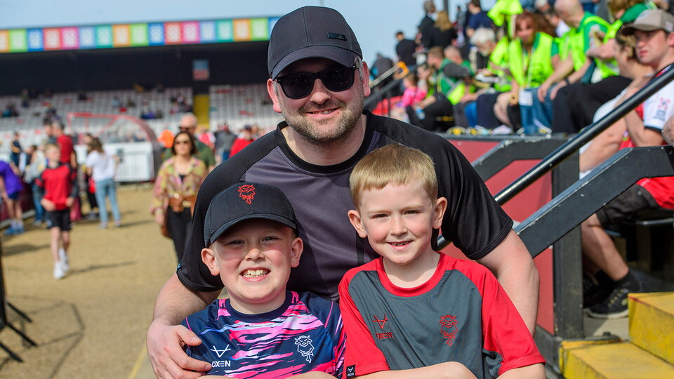 A man and two children pose for a photo