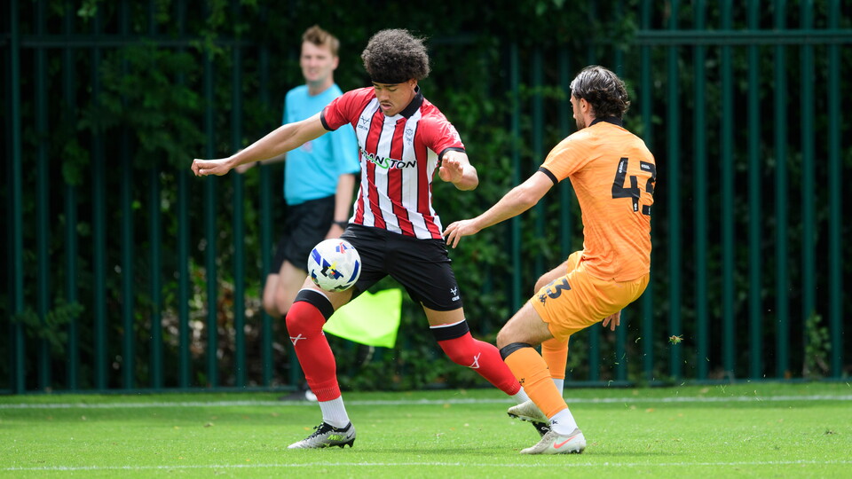 Jovon Makama controls the ball as he runs past a Hull City player