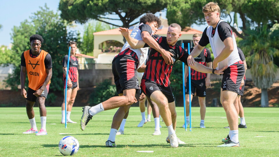 Jovon Makama and Ben House challenge for a football during training