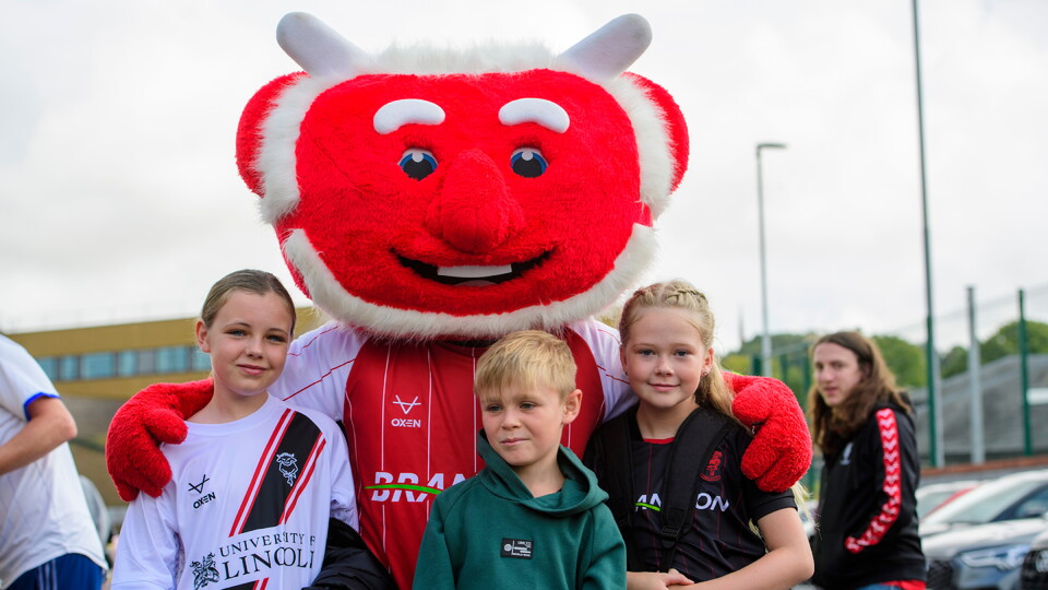 Lincoln City fans enjoy the pre-match atmosphere in the University of Lincoln Fan Village prior to the EFL Sky Bet League One match between Lincoln City and Barnsley at LNER Stadium, Lincoln.