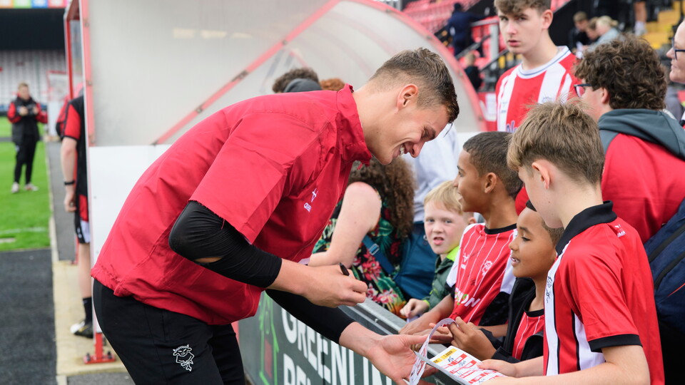 George Wickens signing autographs for supporters at the LNER Stadium.
