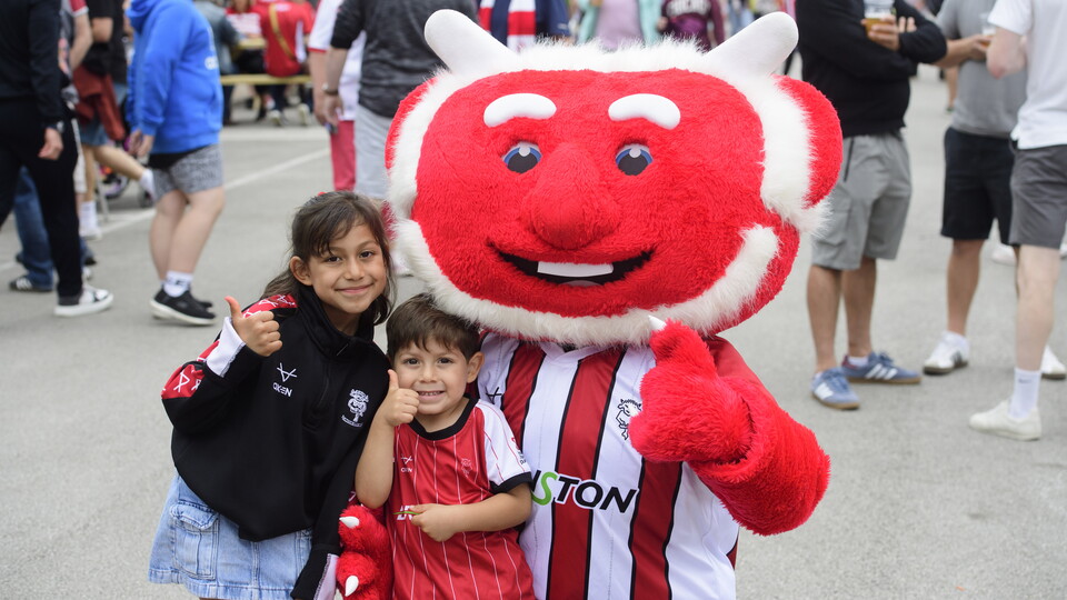 Two children pose with Poacher the Imp