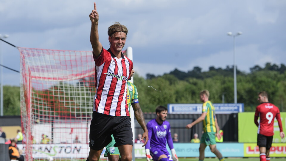 Ryley Towler holds his right hand up in celebration after scoring a goal