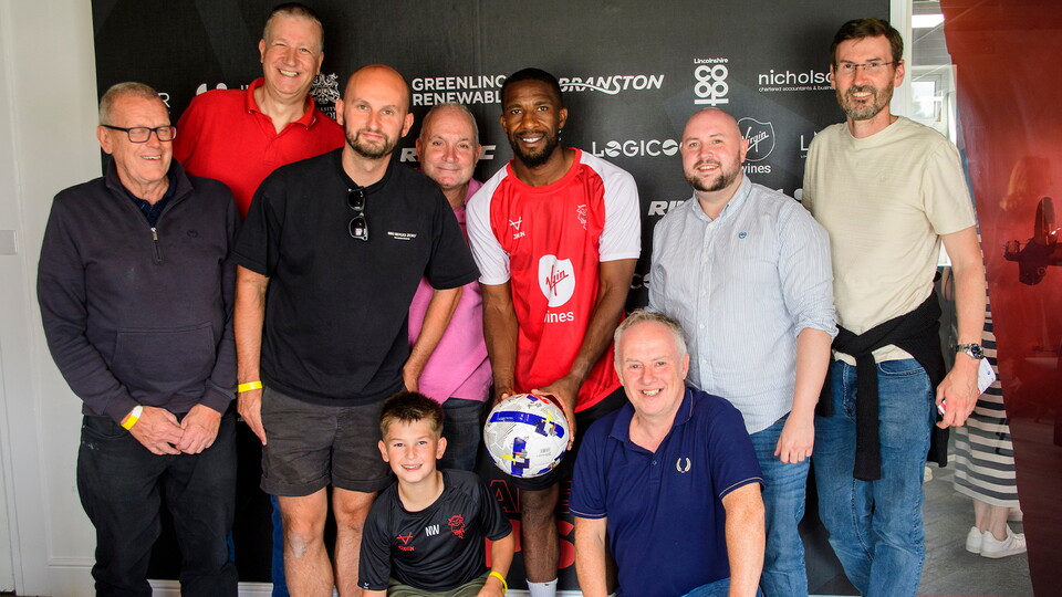 Tendayi Darikwa poses with the matchball sponsors for the Reading home game