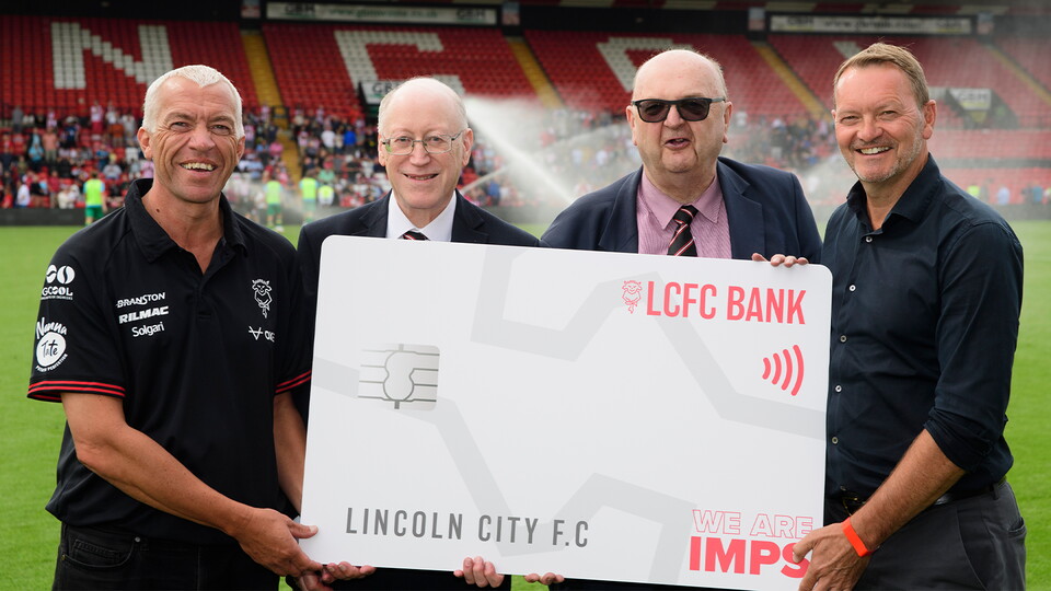 Left to right, Kevin Morley, Peter Grant and Chris Ashton of the Red Imps Travel Section present David Lowes, director of Lincoln City with about £11,000