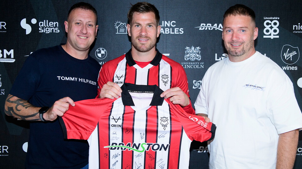 James Collins and two sponsors at the home game against Plymouth Argyle