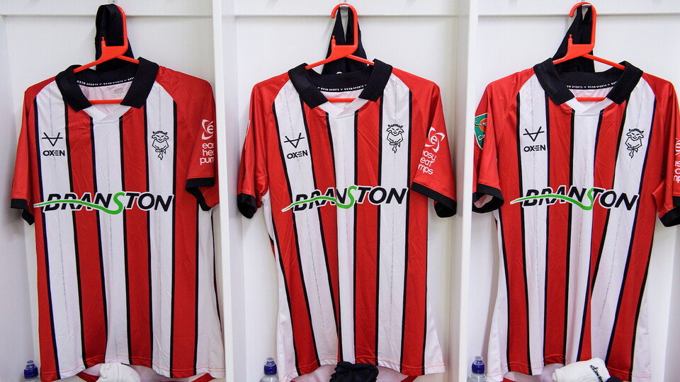 Shirts hung up in the Lincoln City changing room