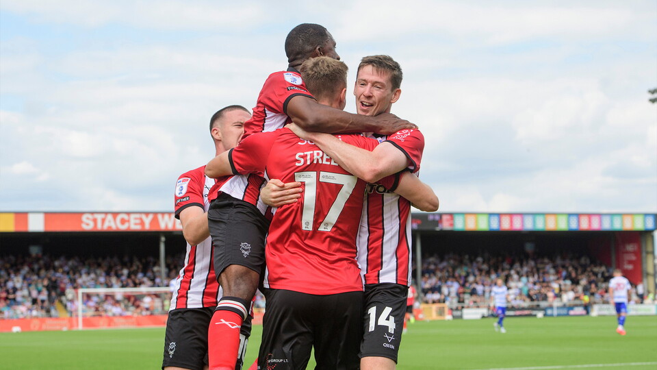Rob Street of Lincoln City, (number 17) celebrates scoring the opening goal with team-mates, from left, Jack Moylan, Tendayi Darikwa and Conor McGrandles during the EFL Sky Bet League One match between Lincoln City and Reading at LNER Stadium, Lincoln.