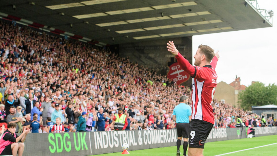 James Collins of Lincoln City celebrates scoring his side's equalising goal to make the score 1-1, from the penalty spot, during the EFL Sky Bet League One match between Lincoln City and Wigan Athletic at LNER Stadium, Lincoln.