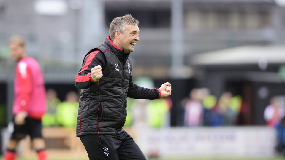 Michael Skubala celebrates after a win. He is wearing a black gillet