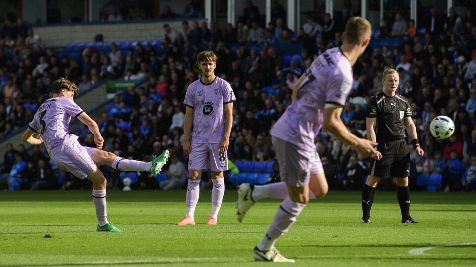 Adam Reach kicks the ball towards goal.