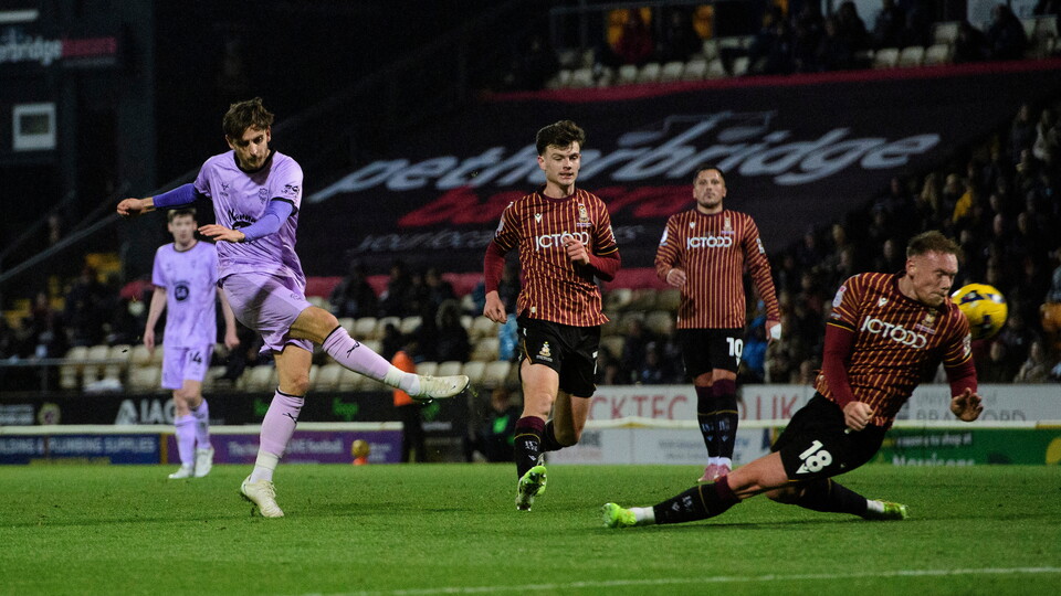 Tom Bayliss of Lincoln City shoots under pressure from Ciaran Kelly of Bradford City during the EFL Sky Bet League One match between Bradford City and Lincoln City at University of Bradford Stadium, Bradford.