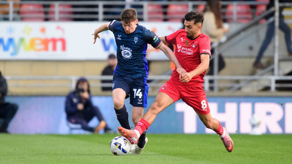 Freddie Draper is challenged for the ball