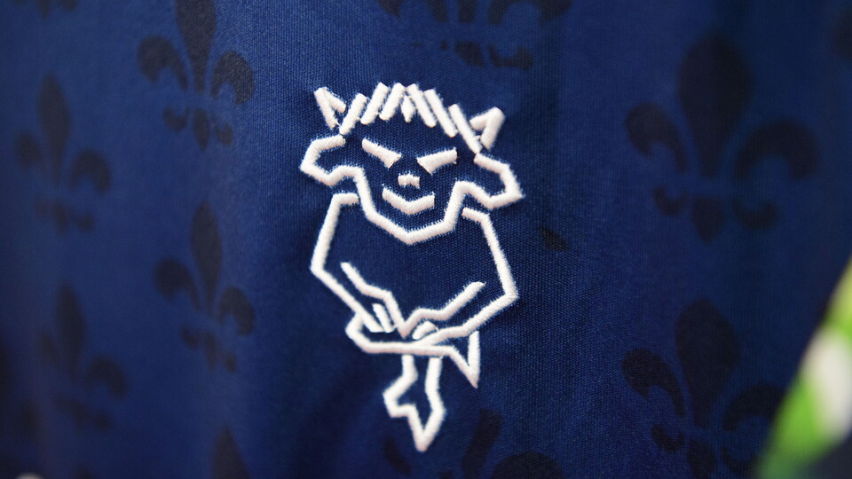 A white Lincoln CIty badge on a blue shirt