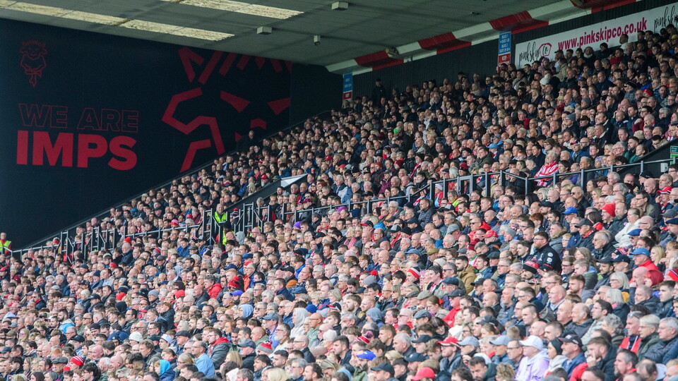 Lincoln City fans watch their team in action during the EFL Sky Bet League One match between Lincoln City and Stevenage at LNER Stadium, Lincoln.