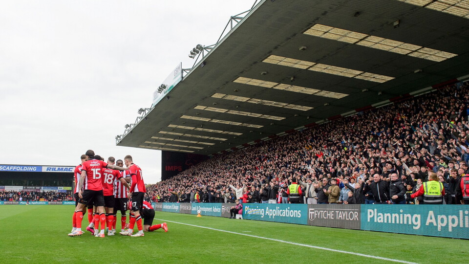 Rob Street of Lincoln City celebrates scoring the opening goal with team-mates during the EFL Sky Bet League One match between Lincoln City and Stevenage at LNER Stadium, Lincoln.
