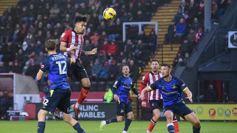 Frankie Okoronkwo leaps to head in a goal against Doncaster Rovers