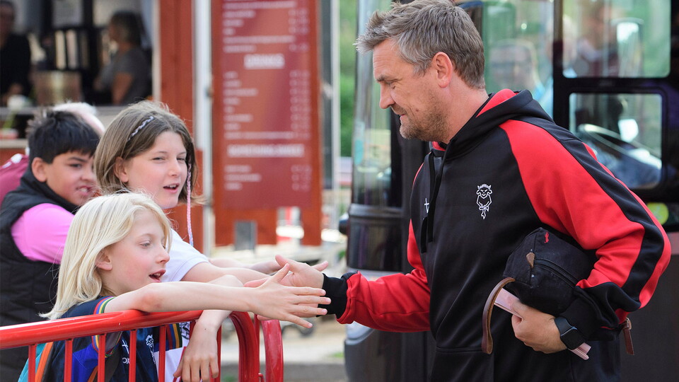 Michael Skubala meets a pair of young Imps fans outside the stadium before a game