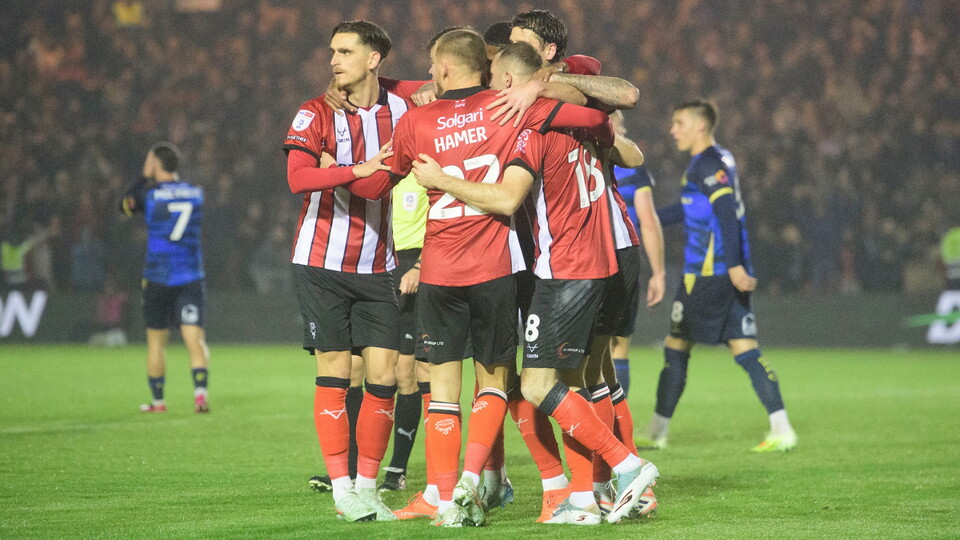 Ben House of Lincoln City celebrates scoring his side's second goal with team-mates during the EFL Sky Bet League One match between Lincoln City and Doncaster Rovers at LNER Stadium, Lincoln.