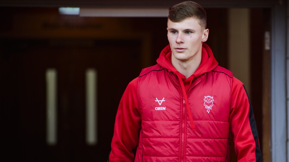 Rob Street wearing a red gillet walks out of the tunnel at Bloomfield Road