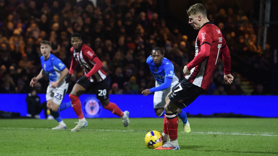Rob Street kicks the ball while taking a penalty kick