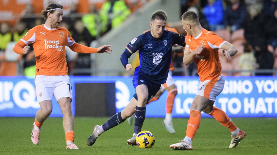 Jack Moylan dribbles with the ball against a Blackpool player