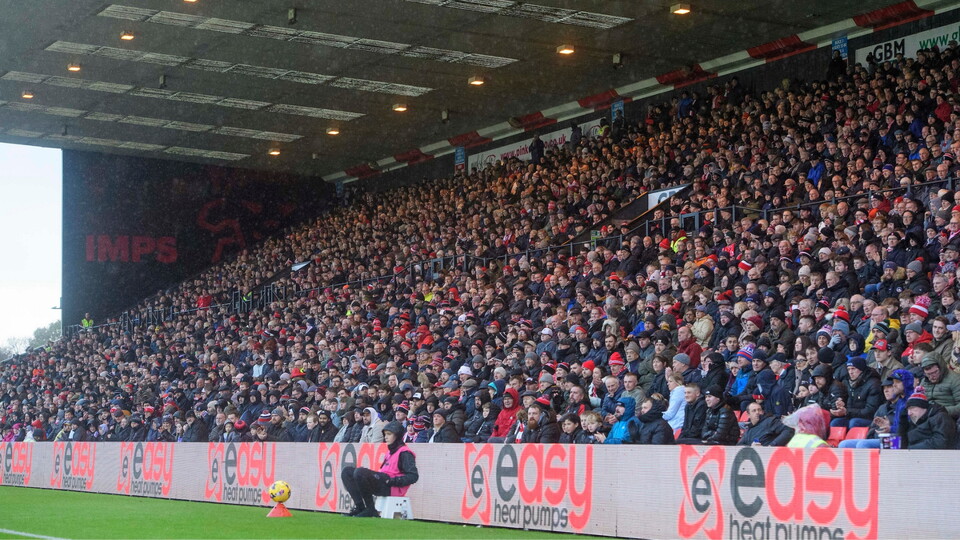 Lincoln City fans watch their team in action during the EFL Sky Bet League One match between Lincoln City and Port Vale at LNER Stadium, Lincoln.