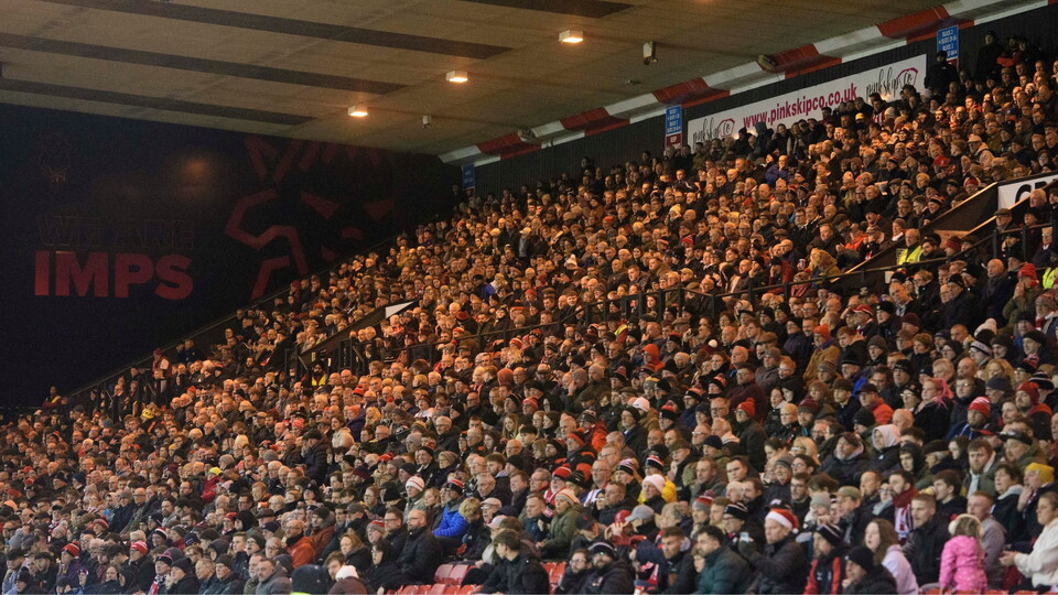 Lincoln City fans watch their team in action during the EFL Sky Bet League One match between Lincoln City and Barnsley at LNER Stadium, Lincoln.