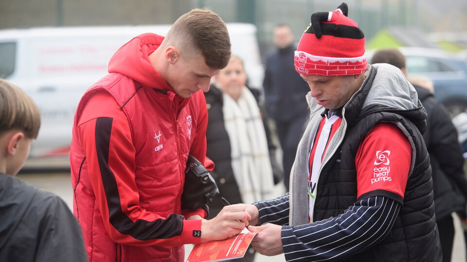 Rob Street of Lincoln City signs an autograph for a fan prior to the EFL Sky Bet League One match between Lincoln City and Cardiff City at LNER Stadium, Lincoln.