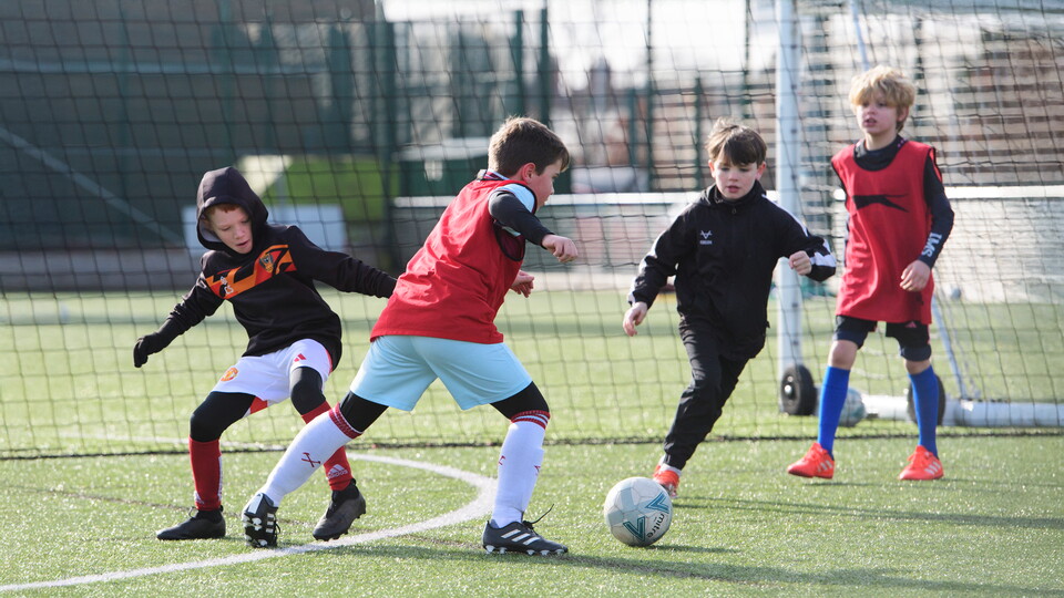 children playing football