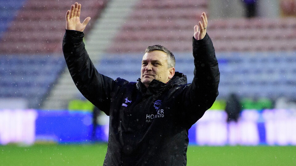 Michael Skubala celebrates at full-time of the Imps' win at Wigan