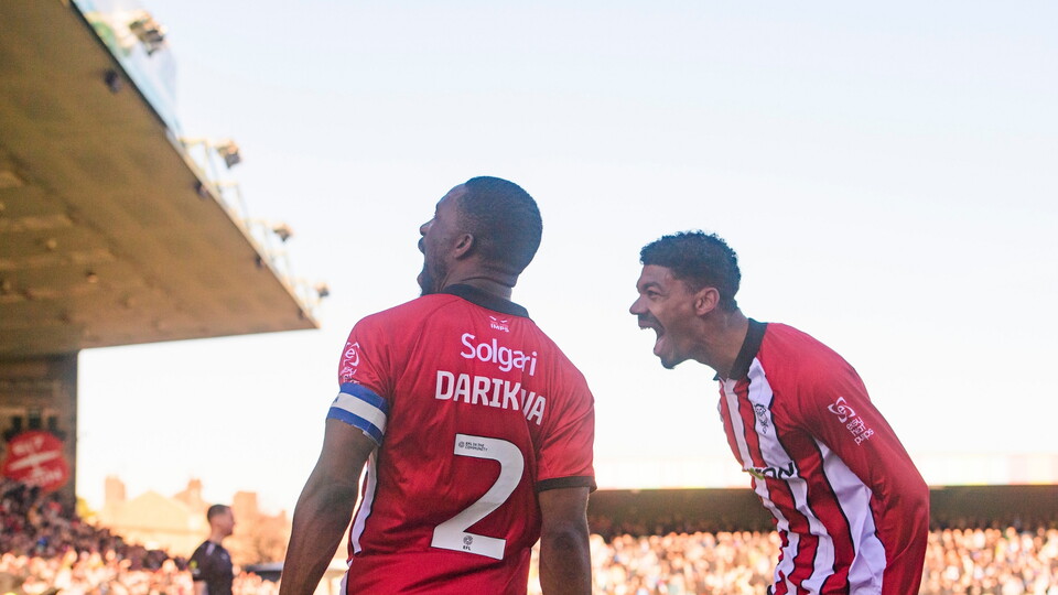 Tendayi Darikwa of Lincoln City, left, celebrates scoring his side's third goal with team-mate Reeco Hackett during the EFL Sky Bet League One match between Lincoln City and Peterborough United at LNER Stadium, Lincoln.