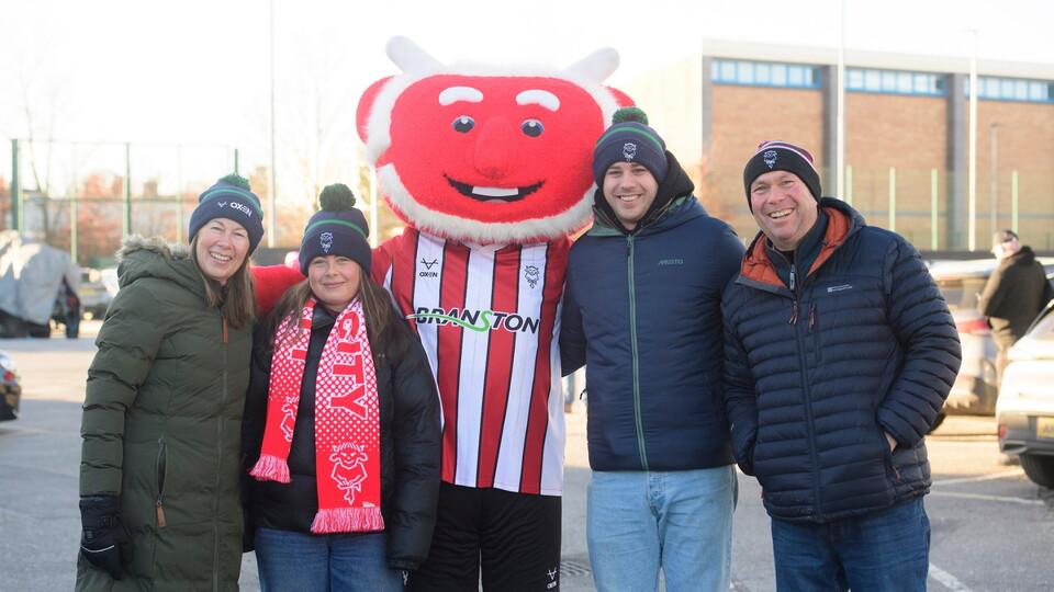 Poacher the Imp, mascot of Lincoln City with fans prior to the EFL Sky Bet League One match between Lincoln City and Peterborough United at LNER Stadium, Lincoln.