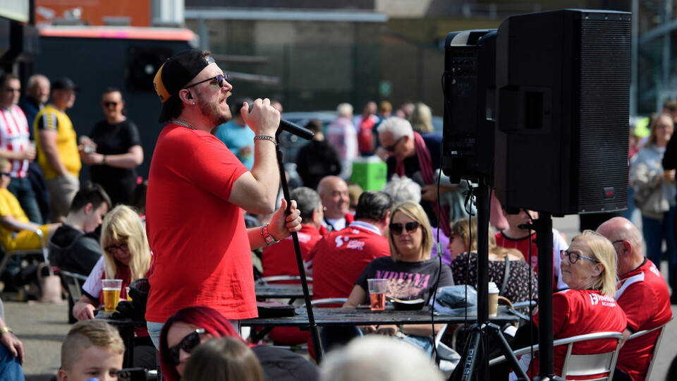 Vocalist and guitarist Ash Wilson performing in the University of Lincoln Fan Village prior to the EFL Sky Bet League One match between Lincoln City and Shrewsbury Town at LNER Stadium, Lincoln.