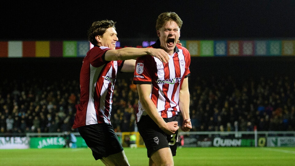 Freddie Draper of Lincoln City, right, celebrates scoring the opening goal with team-mate Adam Reach during the EFL Sky Bet League One match between Lincoln City and Bradford City at LNER Stadium, Lincoln.