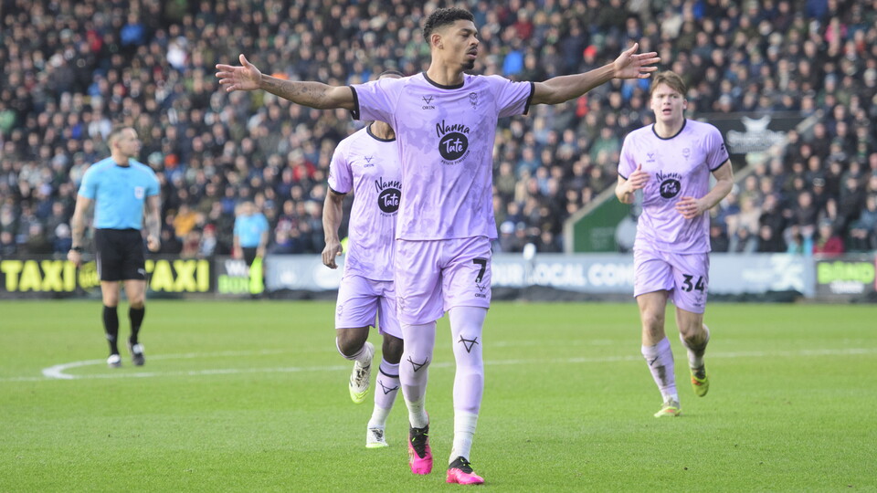 Reeco Hackett holds his arms up as he celebrates a goal