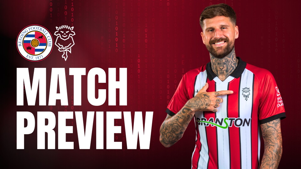 Smiling footballer in a red and white striped jersey points to a team badge. Text reads 'Match Preview. Lincoln City and Reading FC logo on a dark red background.