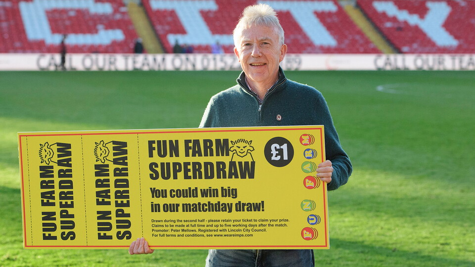 The Imps Superdraw winner from the home game against Rotherham United poses with a giant cheque