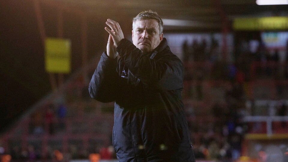 Michael Skubala applauds the fans after Lincoln's win at Exeter