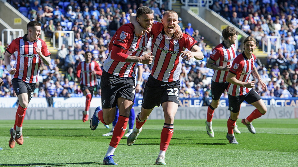 Lincoln City celebrate going ahead in the game at Reading