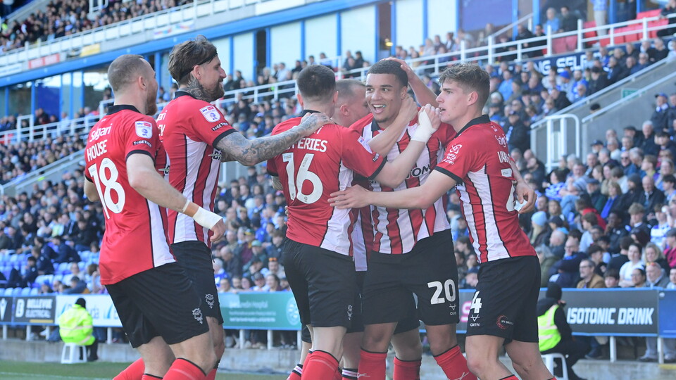 Lincoln City players celebrate after scoring a goal