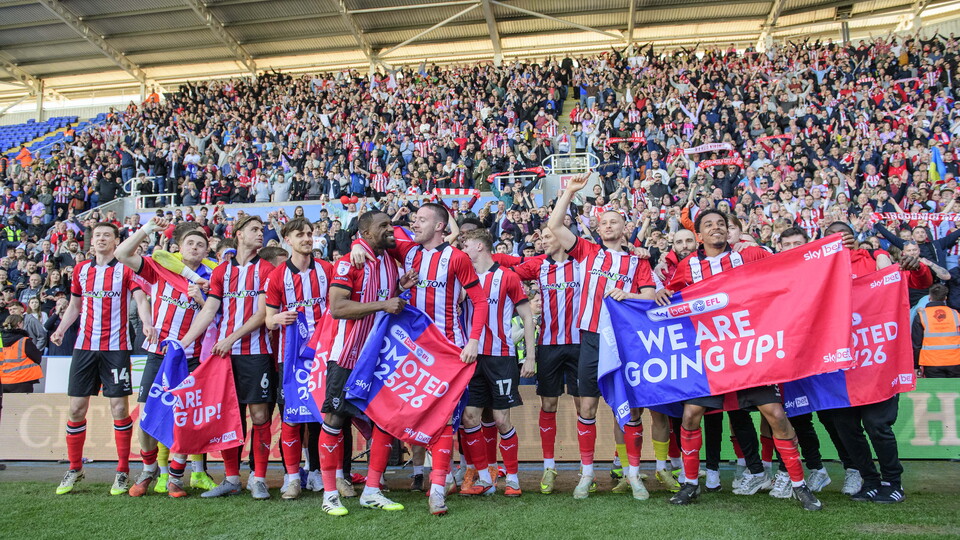 Lincoln City players celebrate promotion