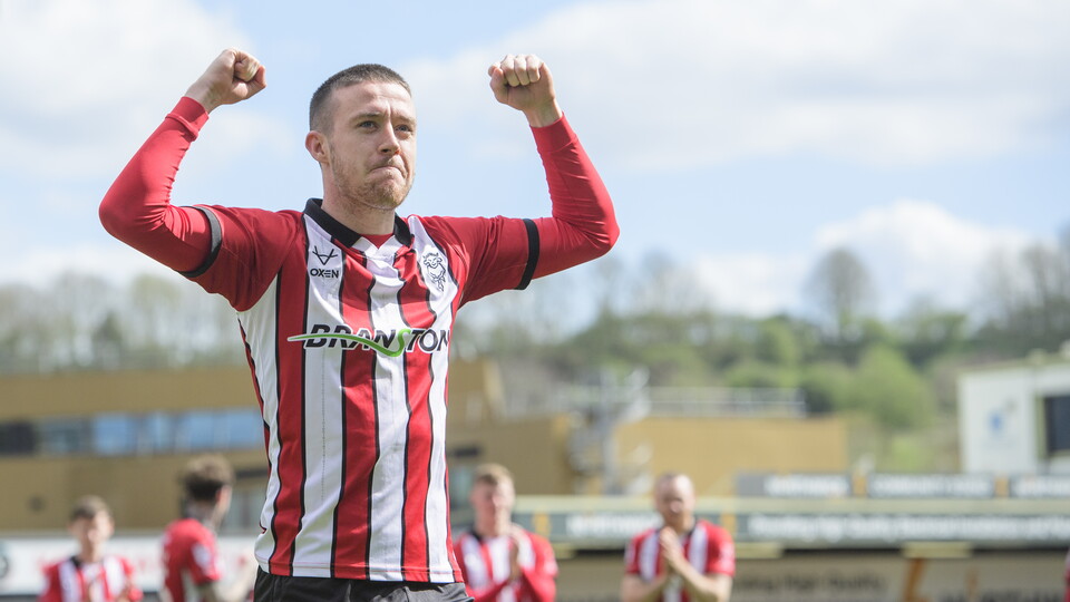 Jack Moylan holds his hand up in celebration after scoring a goal