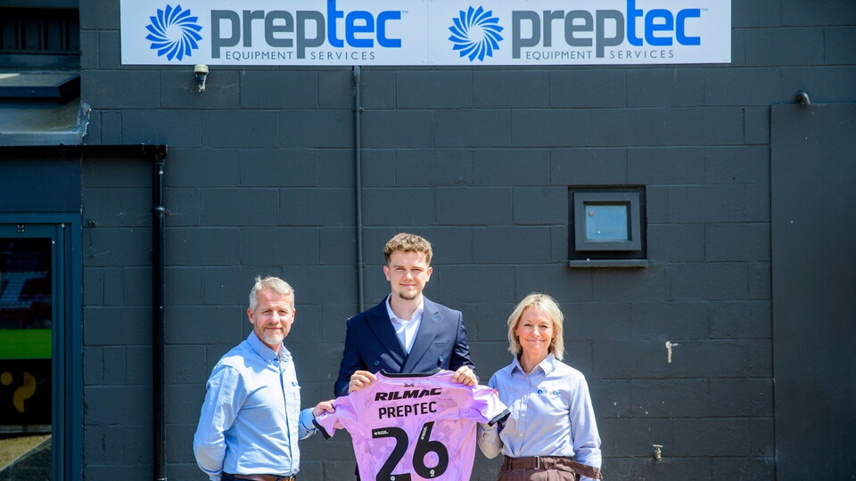Three people stand in front of a black wall with "Preptec Equipment Services" signage.