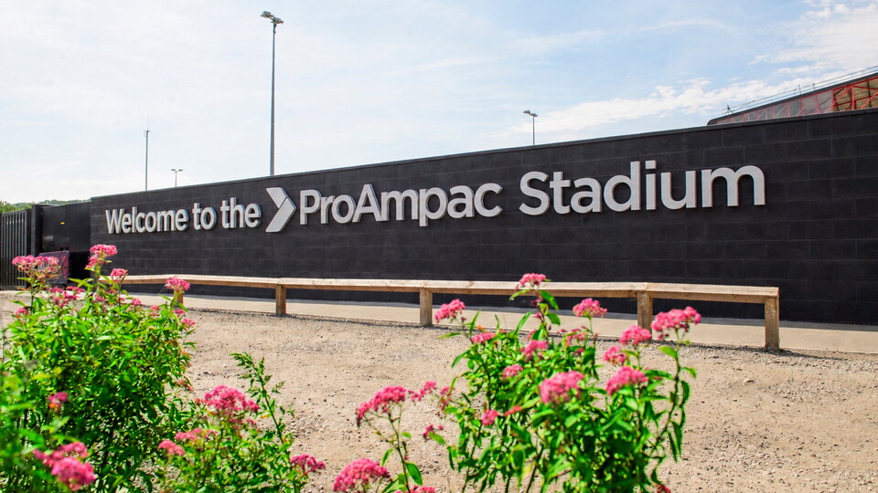 Flowers in front of a sign which reads Welcome to the ProAmpac Stadium