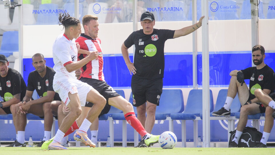 Callum Elder challenges for the football