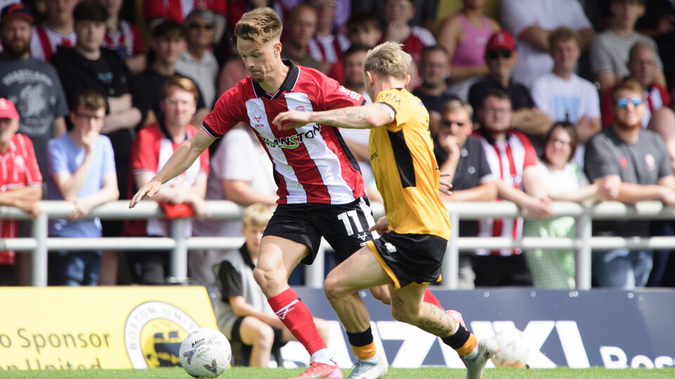 Oscar Thorn dribbles a football past a Boston United player