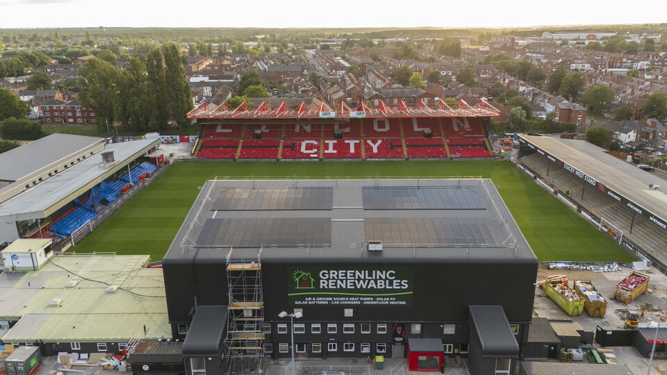A view from above a football stand which clearly shows solar panels on the roof