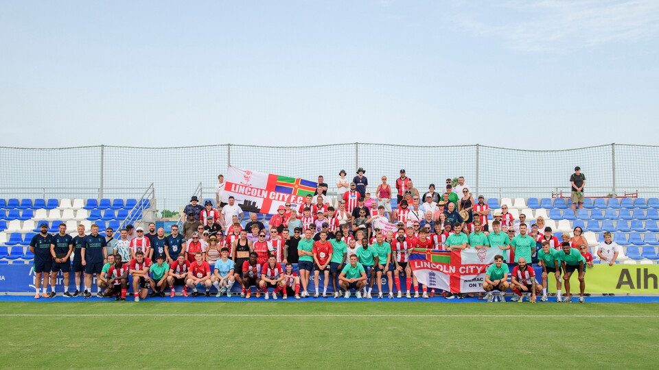 Lincoln City players and staff pose for a photograph with fans following the pre-season friendly match between Leyton Orient and Lincoln City at Pinatar Arena, San Pedro del Pinatar, Murcia, Spain.